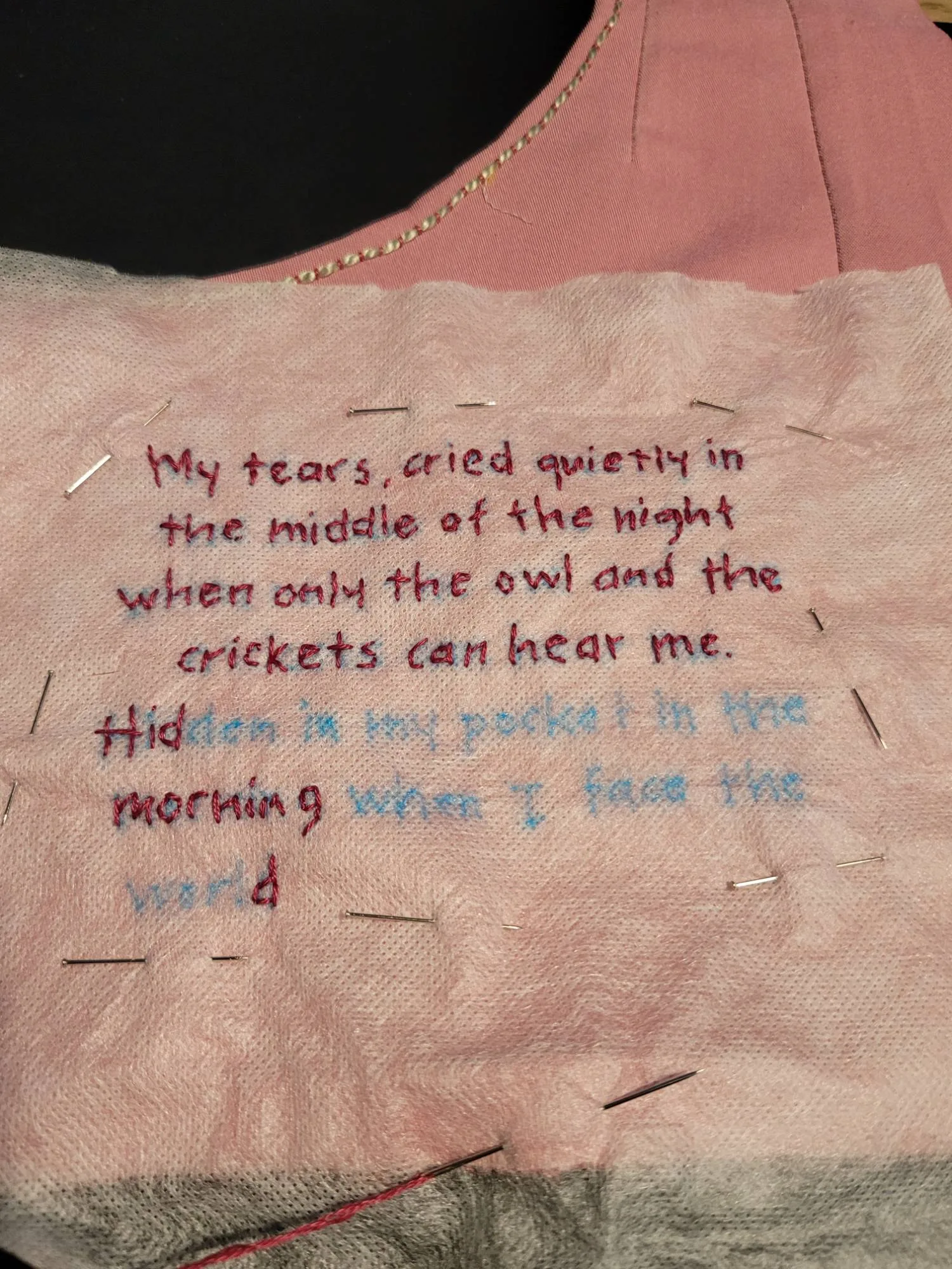 A hand-embroidered testimony reading “My tears, cried quietly in the middle of the night…”