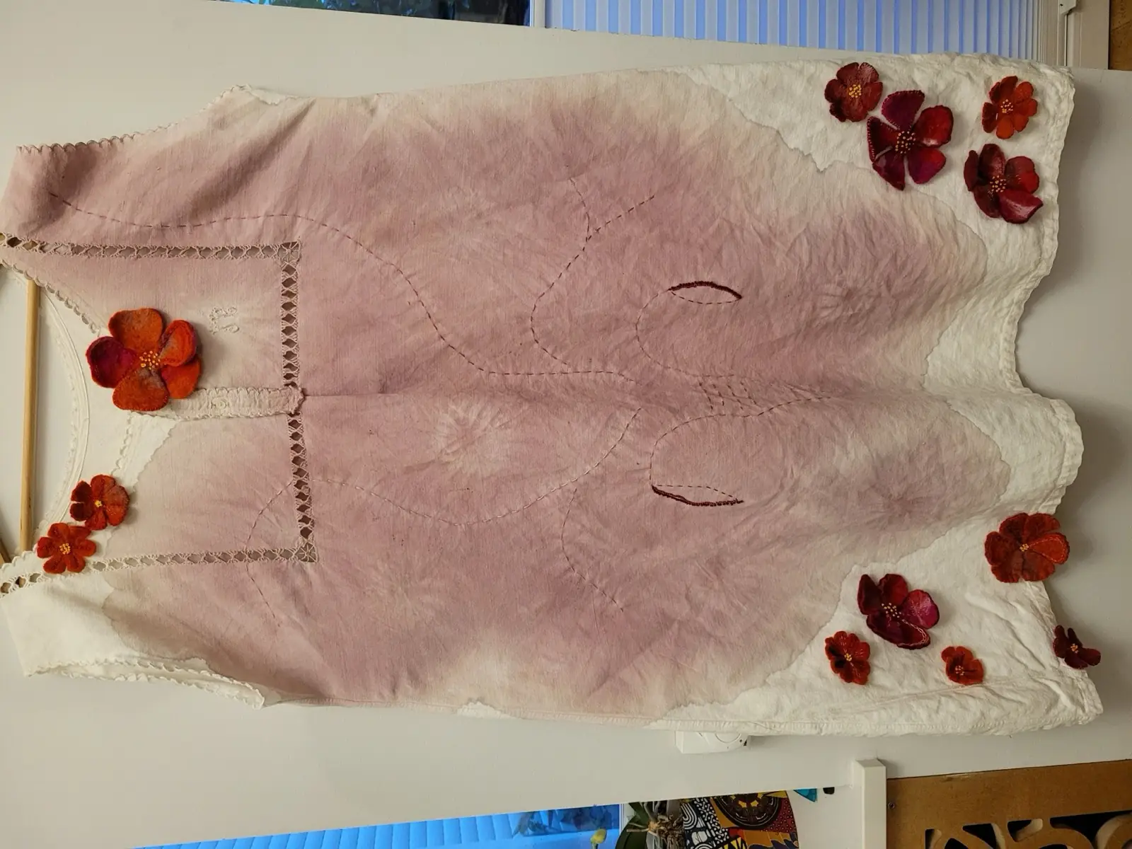Hand-dyed and embroidered red textile dress, a Red Thread craft piece